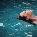Woman floating on body of water